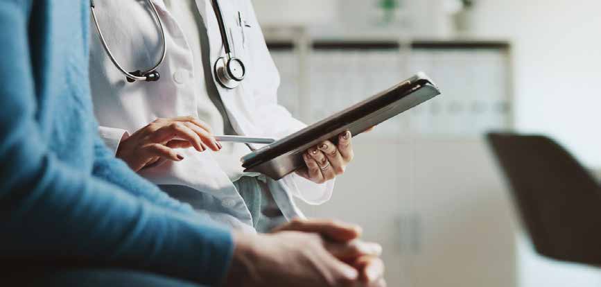 Profissional de saúde mostra informações em um tablet para uma paciente